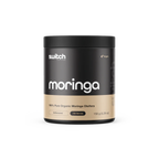 Black and beige container of switch Nutrition Moringa powder on a white background